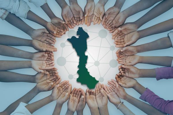 A unique image of a large group of children of East African descent showing their hands in a circular pattern. This could be as interpreted as in need of help, or asking for assistance.